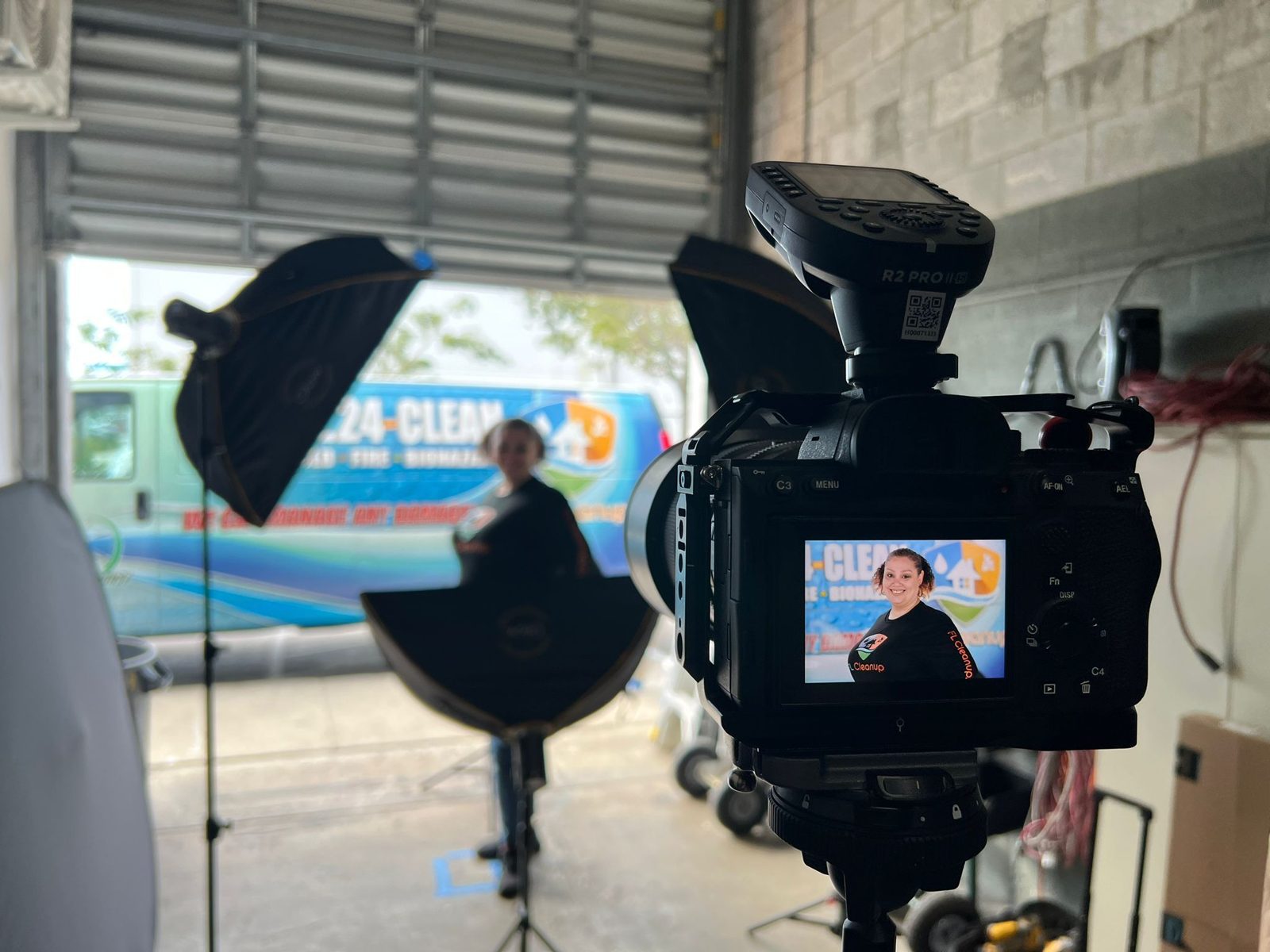 Backdrop and camera set up outside beside a wrapped truck