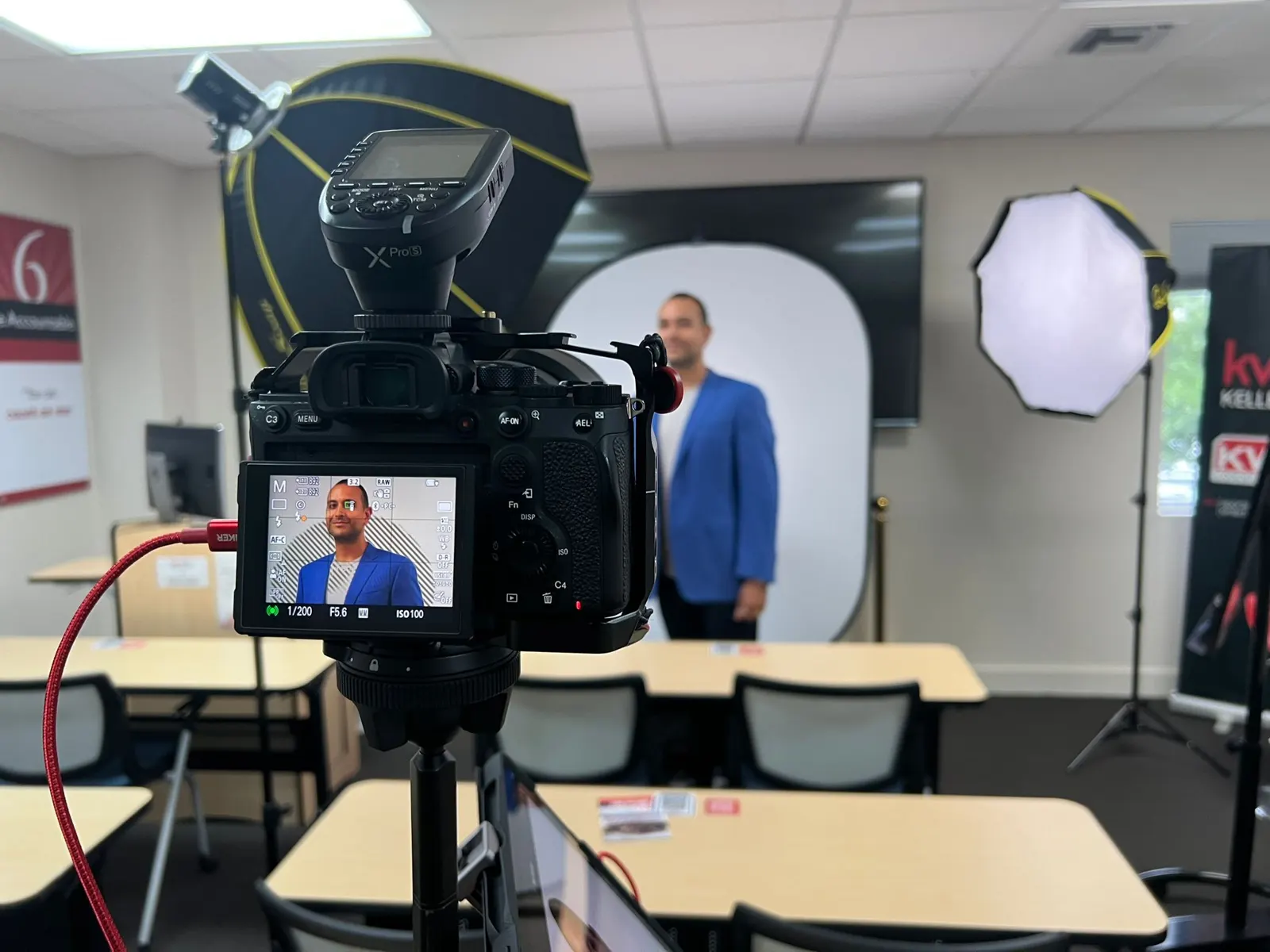 A headshot set in a client's office, with the live frame on the camera