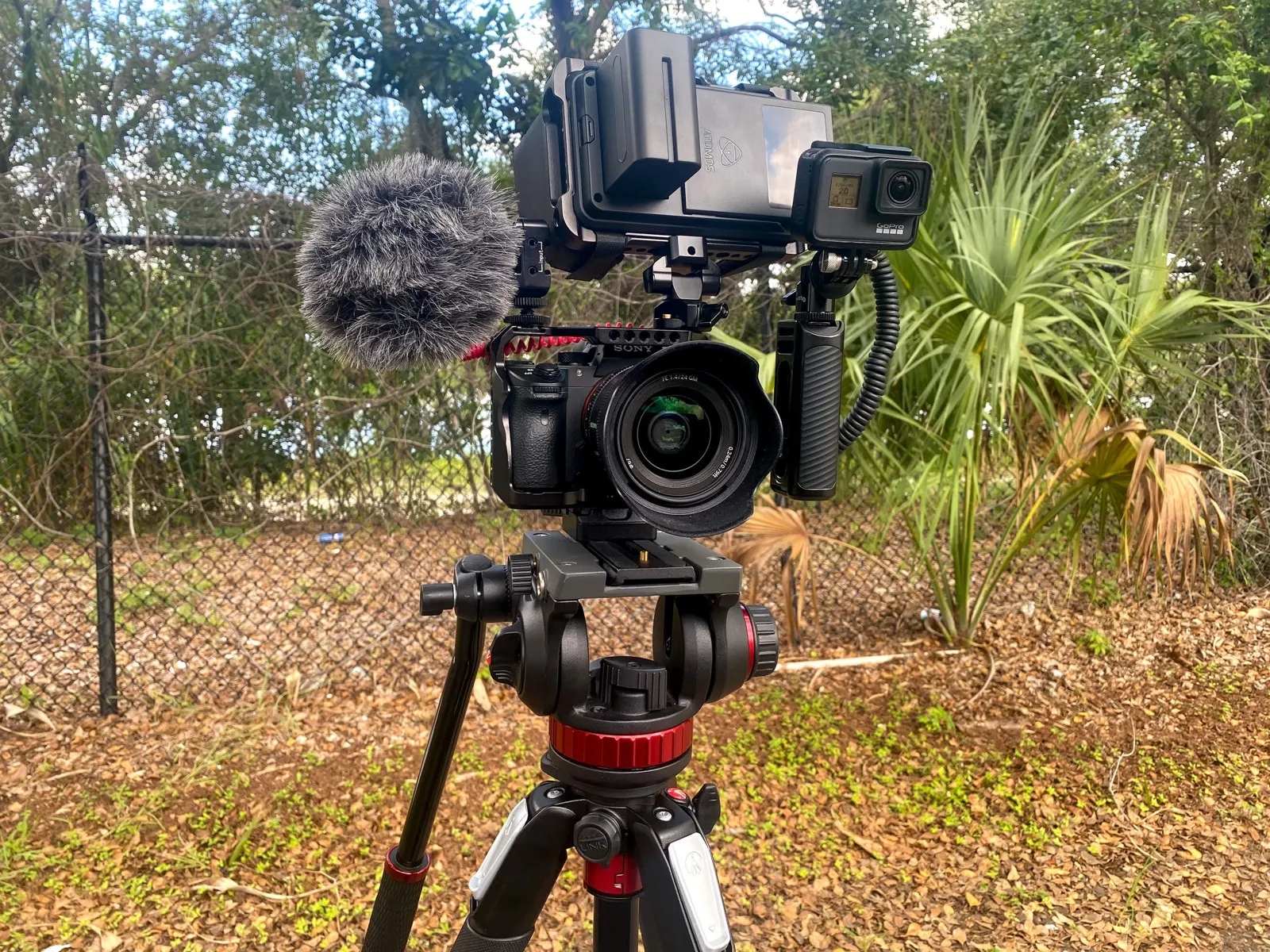 A video camera with a shotgun mic set up outdoors
