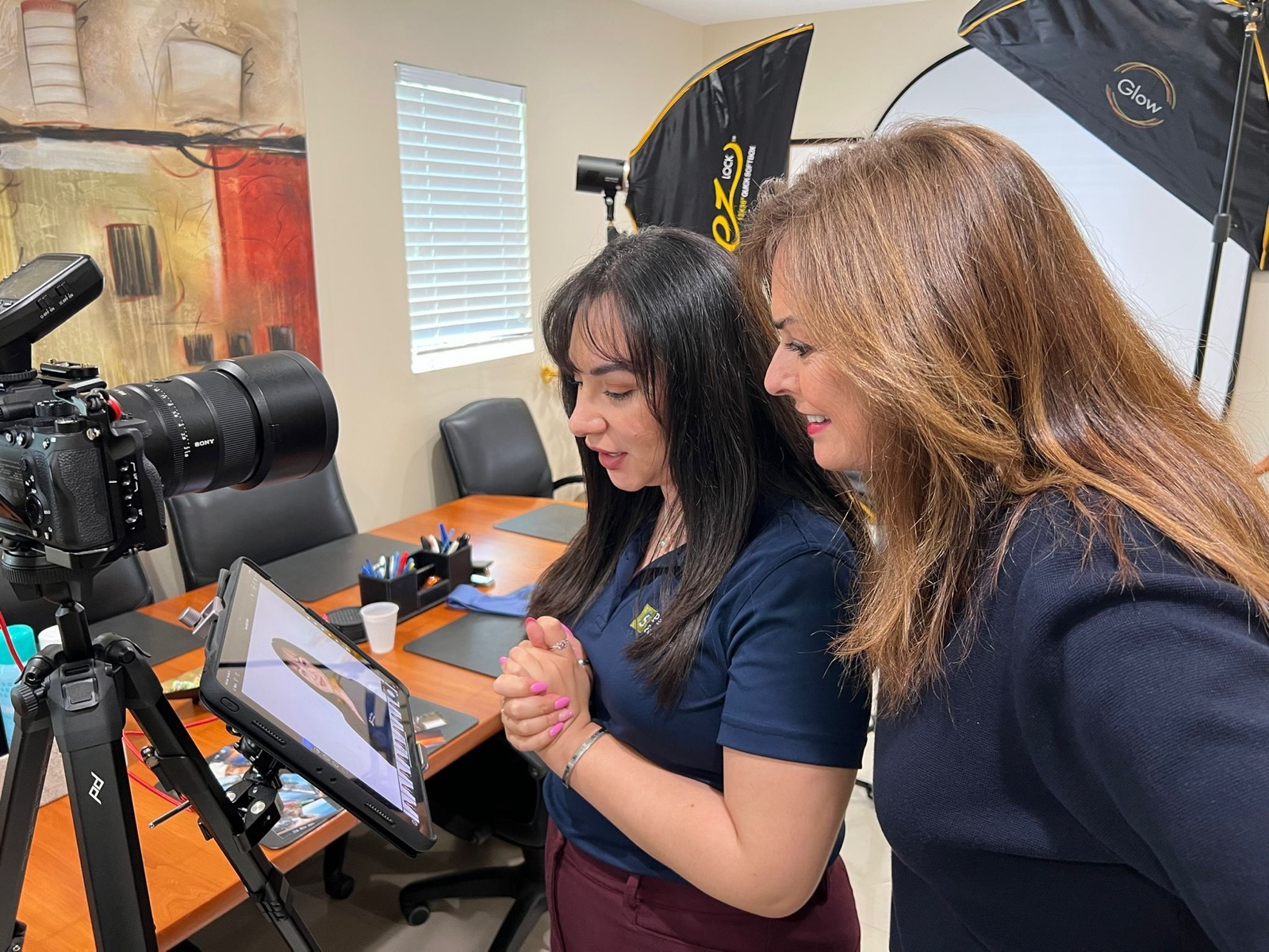 Reviewing photos with a client on location during a shoot