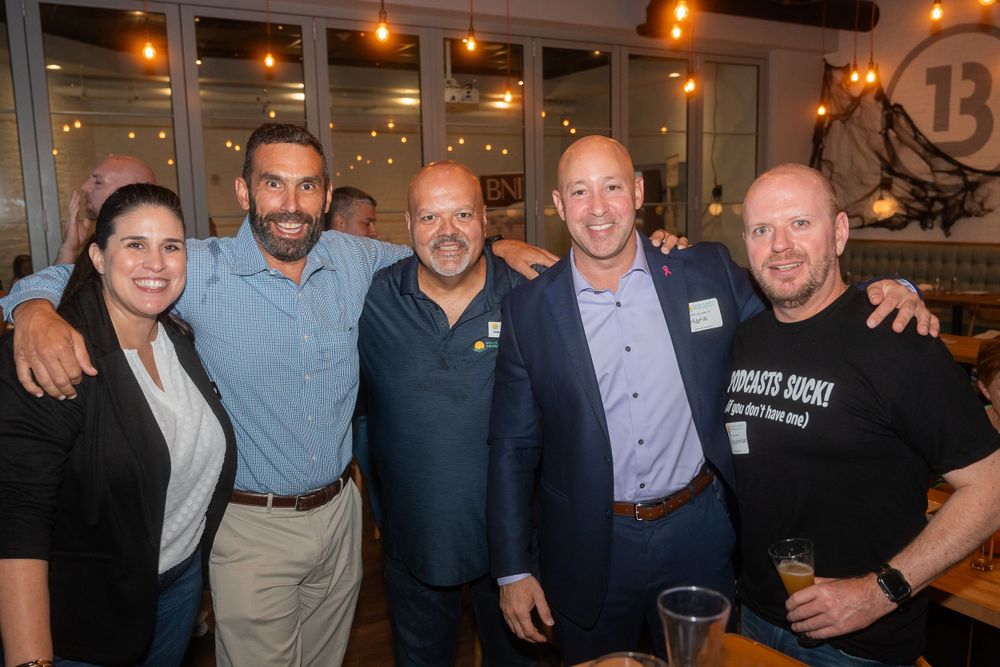 Group of colleagues posing together at an indoor corporate networking event