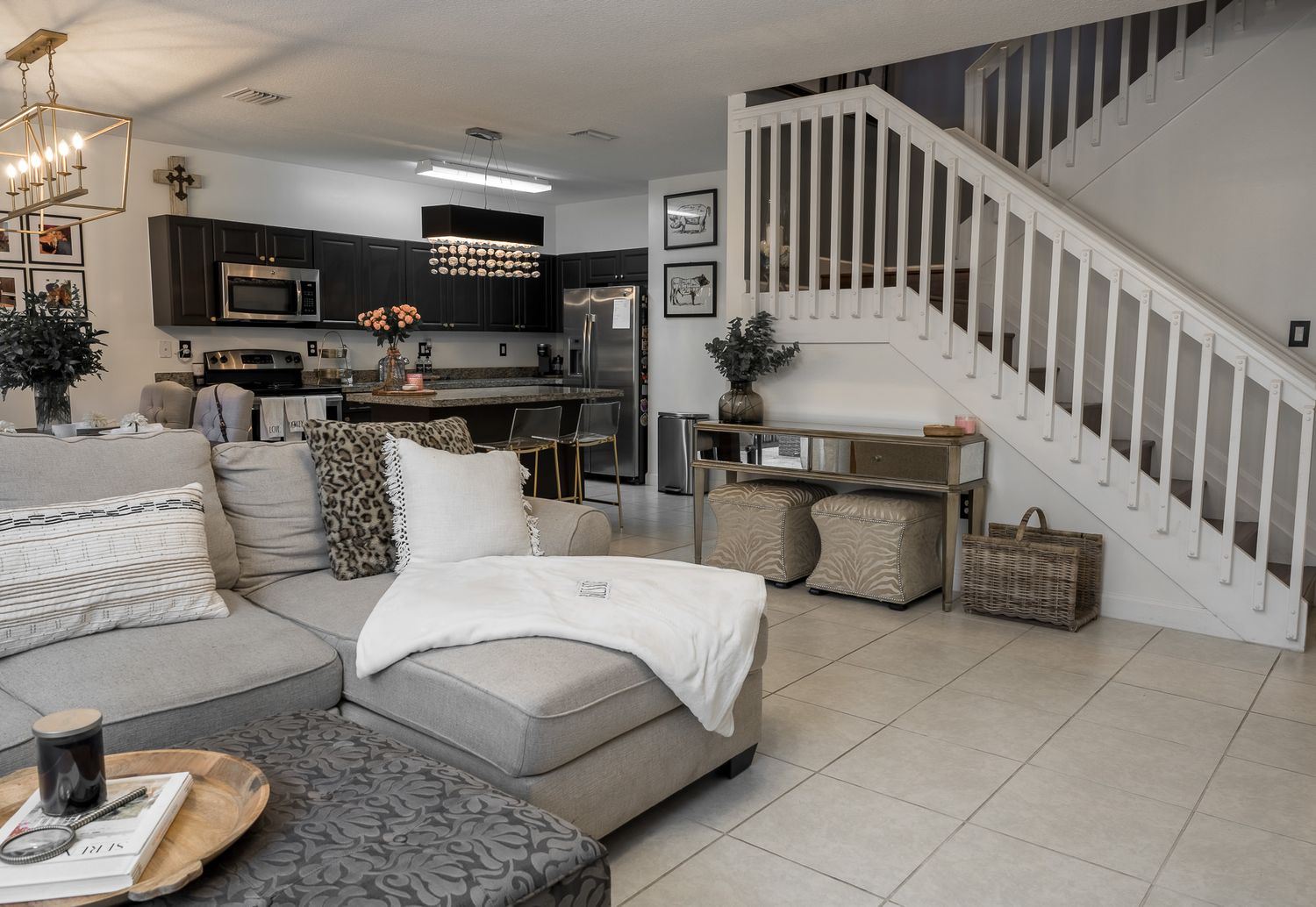 Great room with a vaulted ceiling, wrought iron staircase, and a sectional sofa