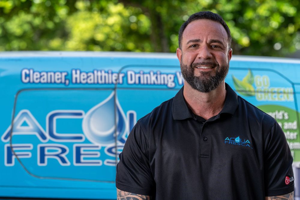 On-location team headshot in front of a branded company van