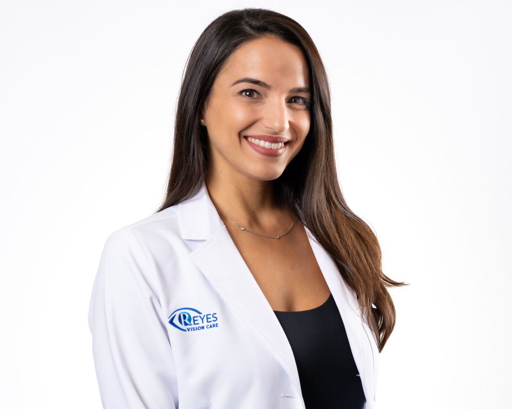 On-location headshot for a vision care practice, white coat with the practice logo