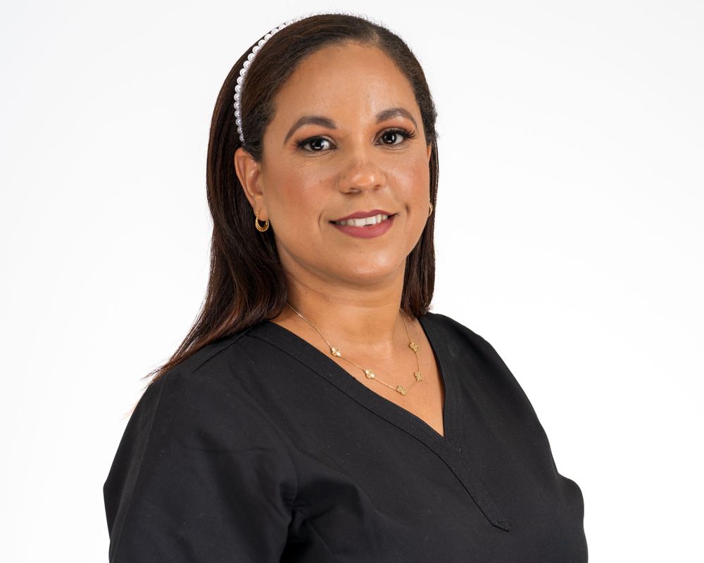 Studio headshot on white, woman with a headband and black top