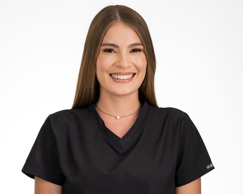 Studio headshot on white, long light brown hair, black top