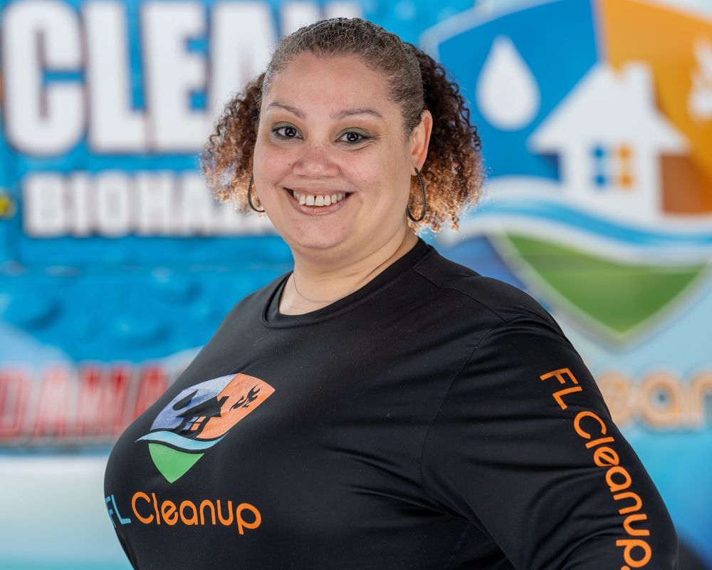 On-location team headshot for a restoration company, branded polo in front of the company banner